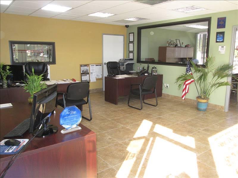 Front office and reception with wood desks and a US flag